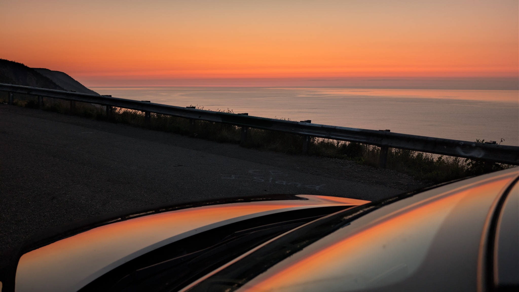 Sunset reflected on a car beside the coast in Cape Breton